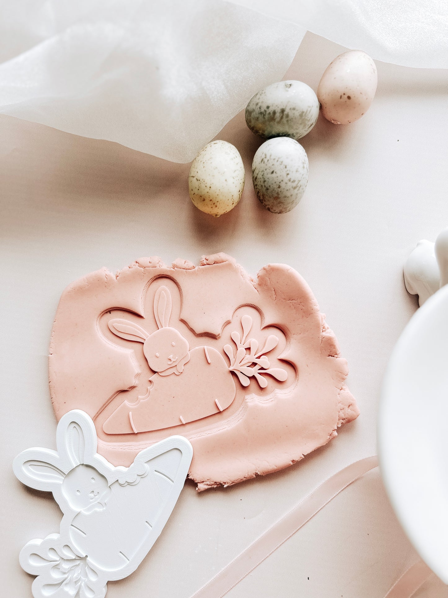 Bunny peeking over carrot debosser and cutter