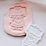 Santa holding present stamp and cutter