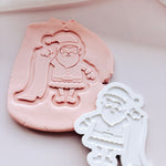 Santa holding a list stamp and cutter