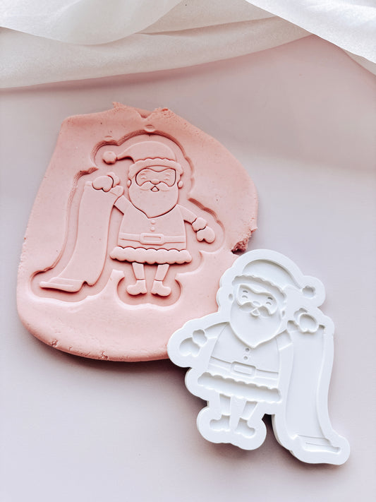 Santa holding a list stamp and cutter