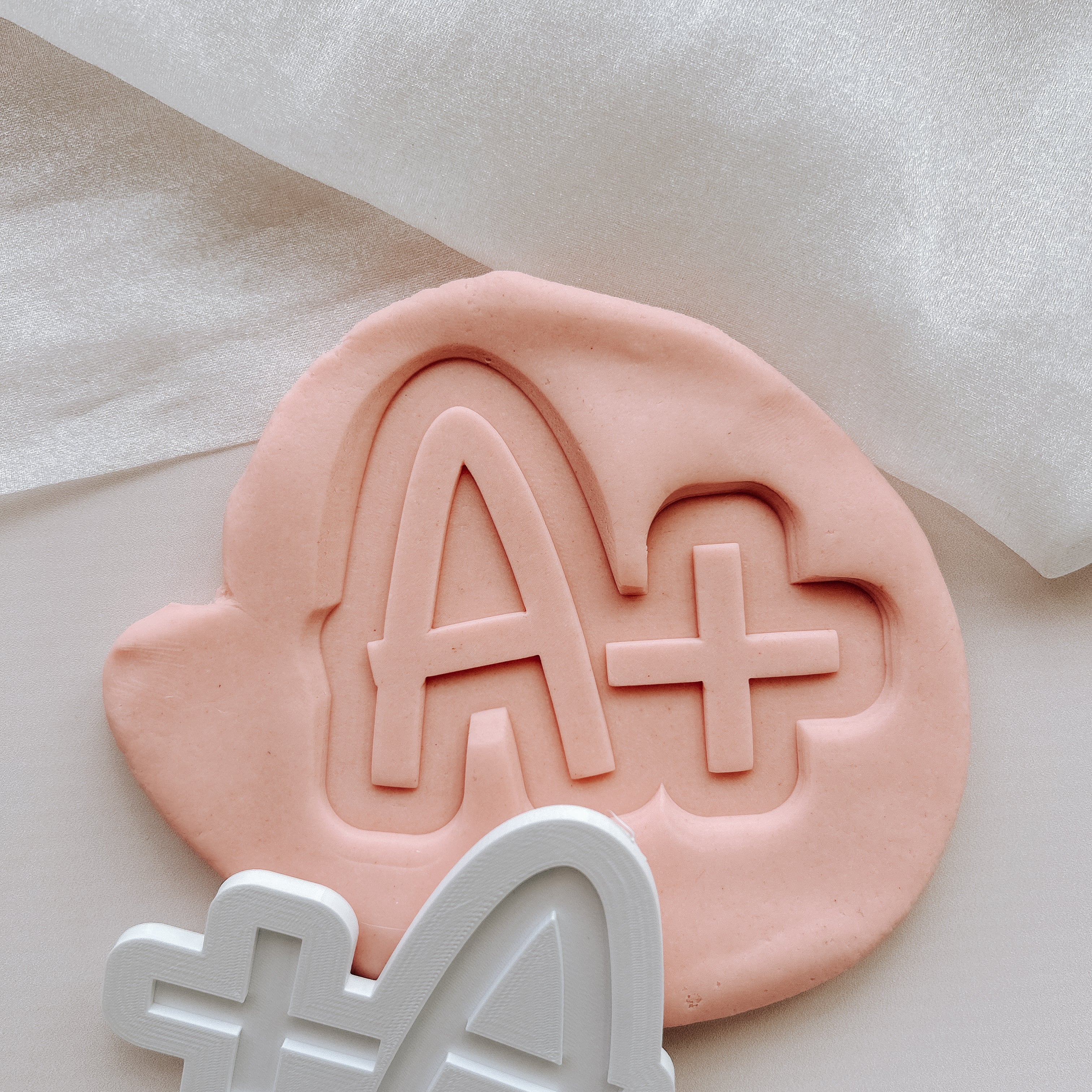 A + stamp and cutter