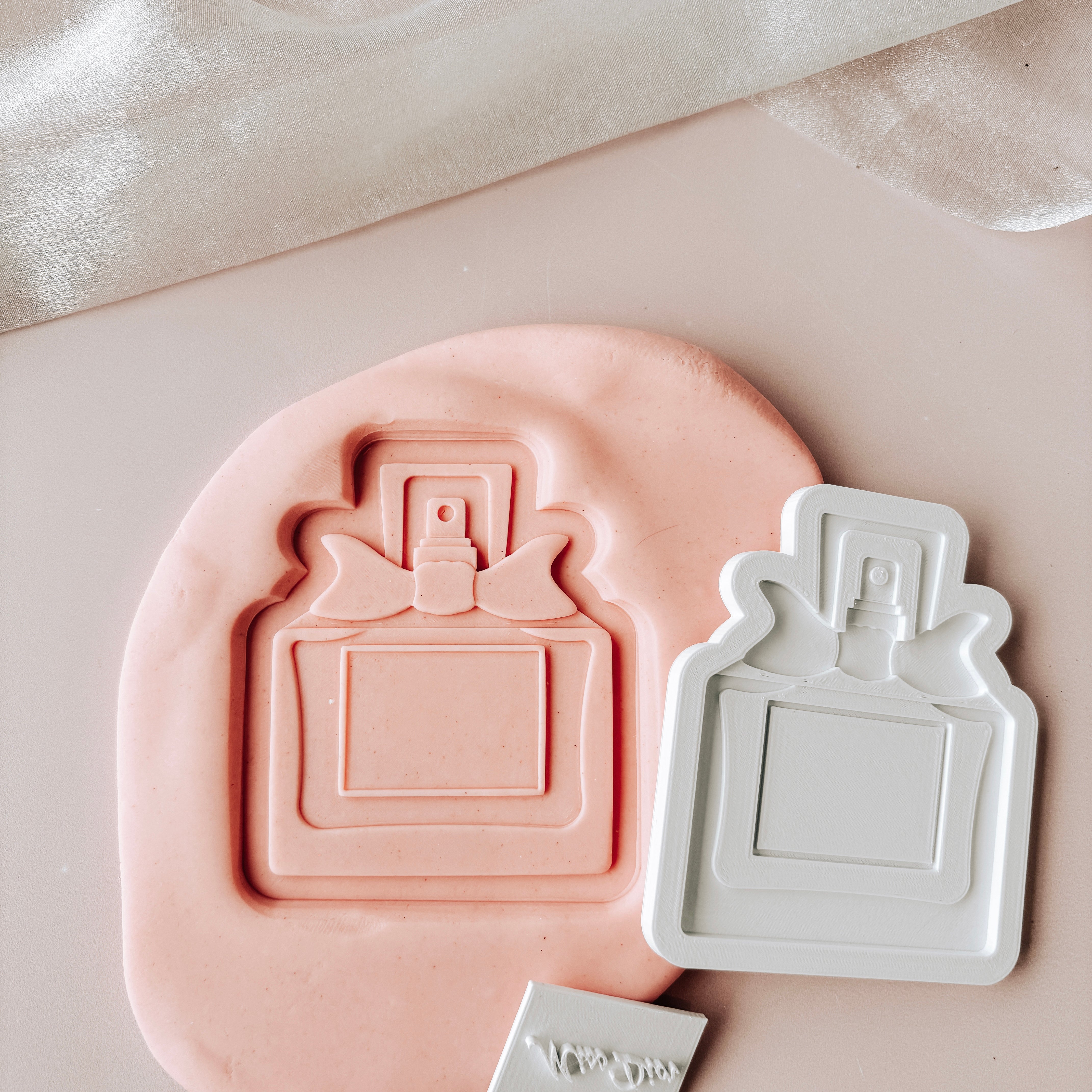 Perfume bottle with mini stamp and cutter