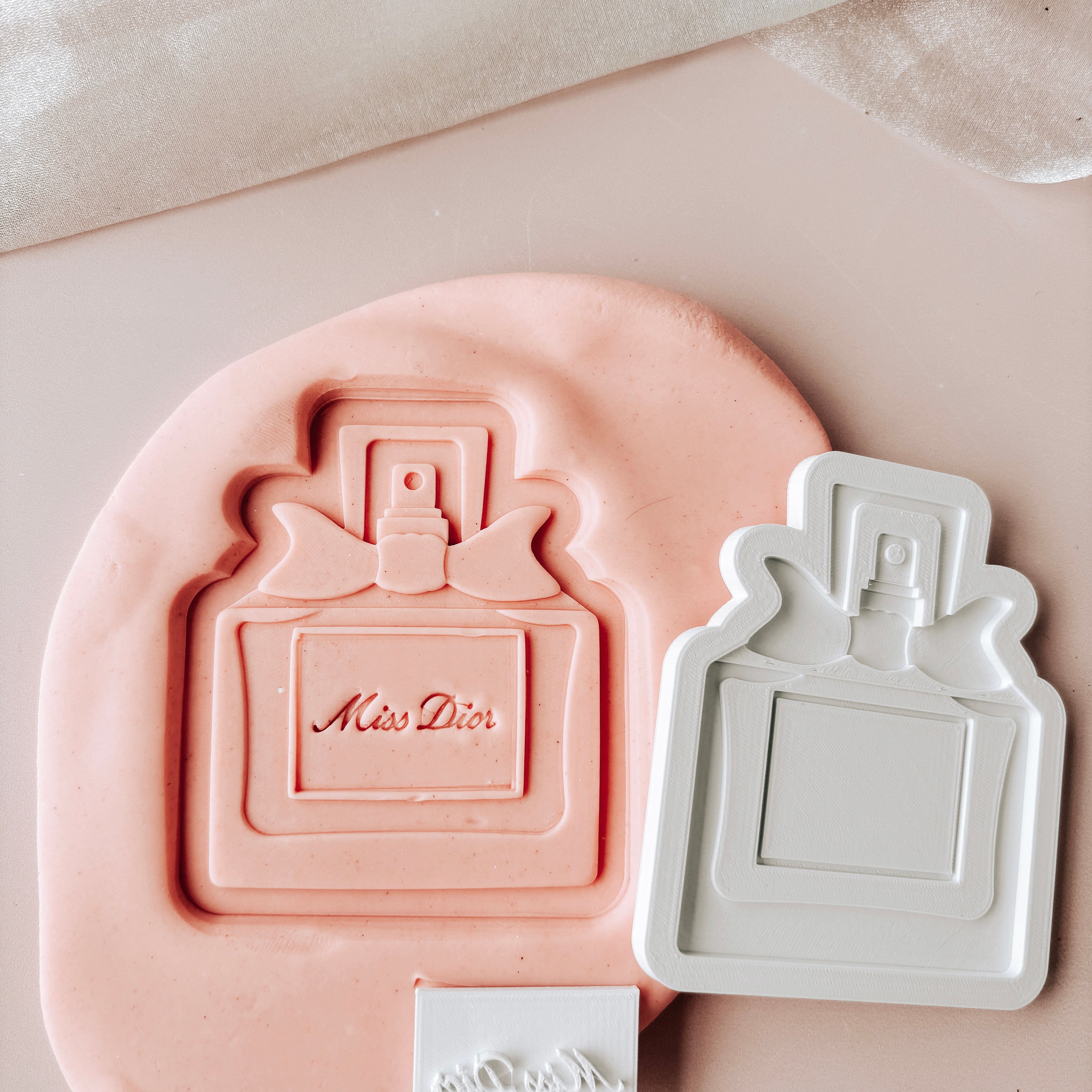 Perfume bottle with mini stamp and cutter