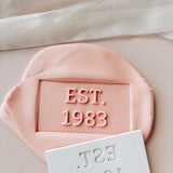 EST. 1983 stamp and cutter