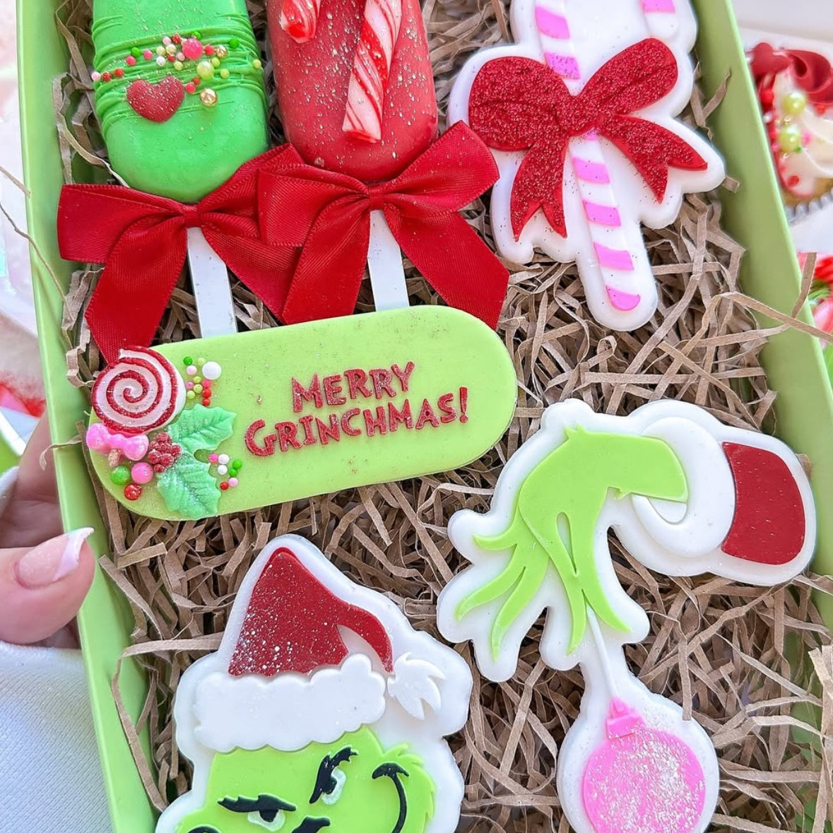 Grinch hand holding bauble stamp and cutter