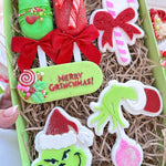 Grinch hand holding bauble stamp and cutter