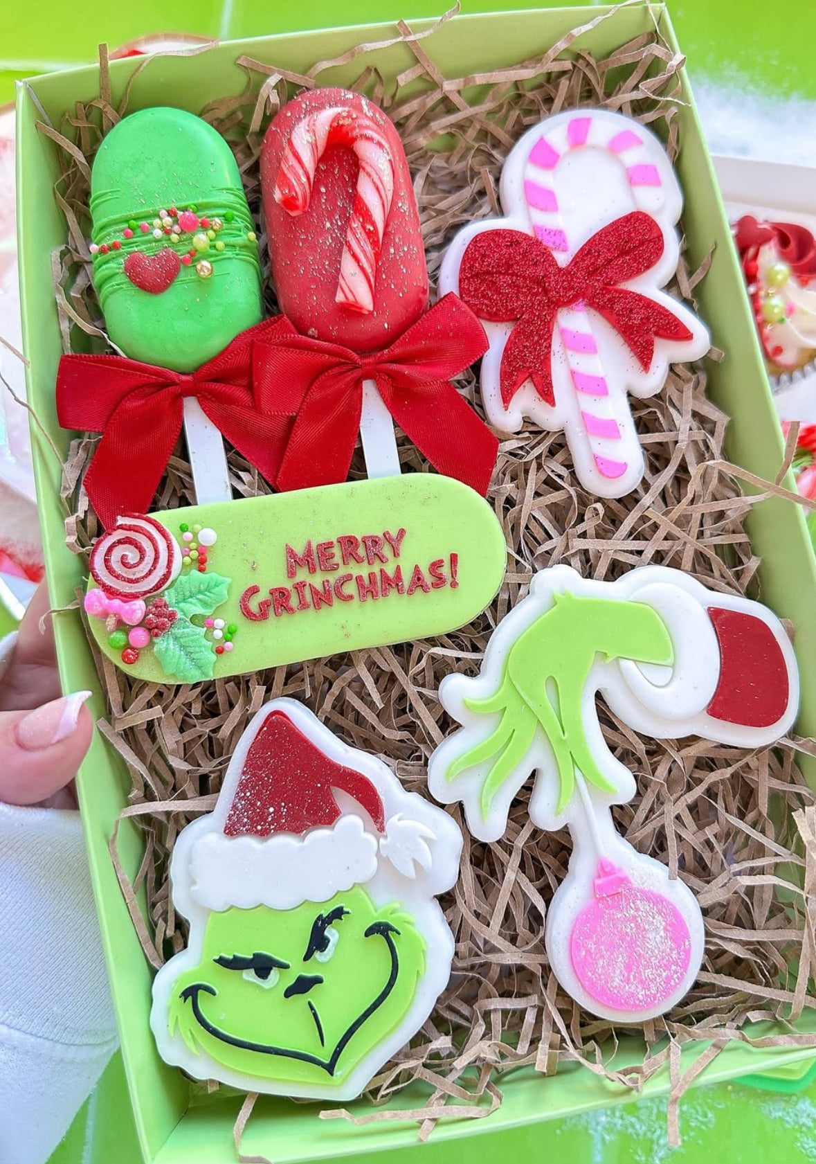 Grinch hand holding bauble stamp and cutter