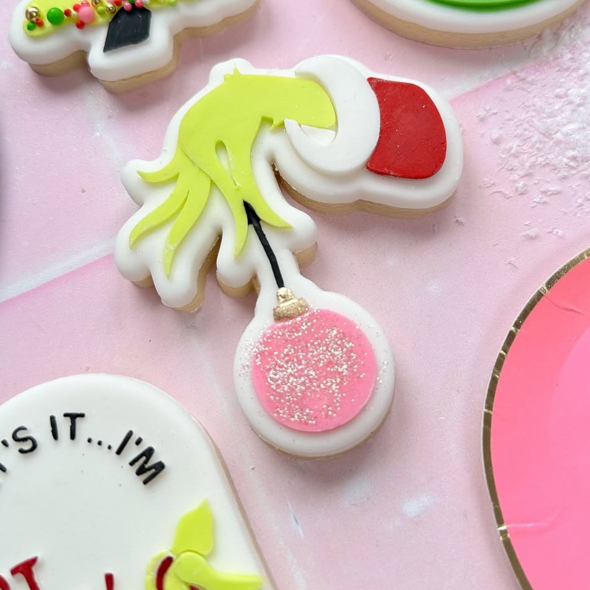 Grinch hand holding bauble stamp and cutter