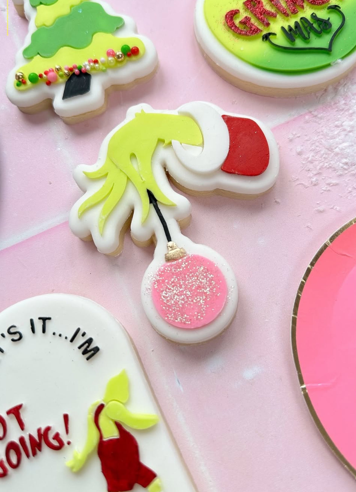 Grinch hand holding bauble stamp and cutter