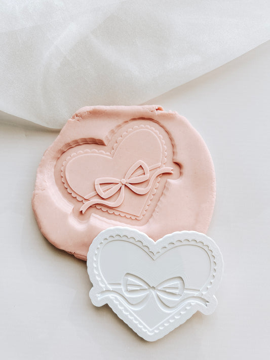 Scalloped edged heart with bow stamp and cutter