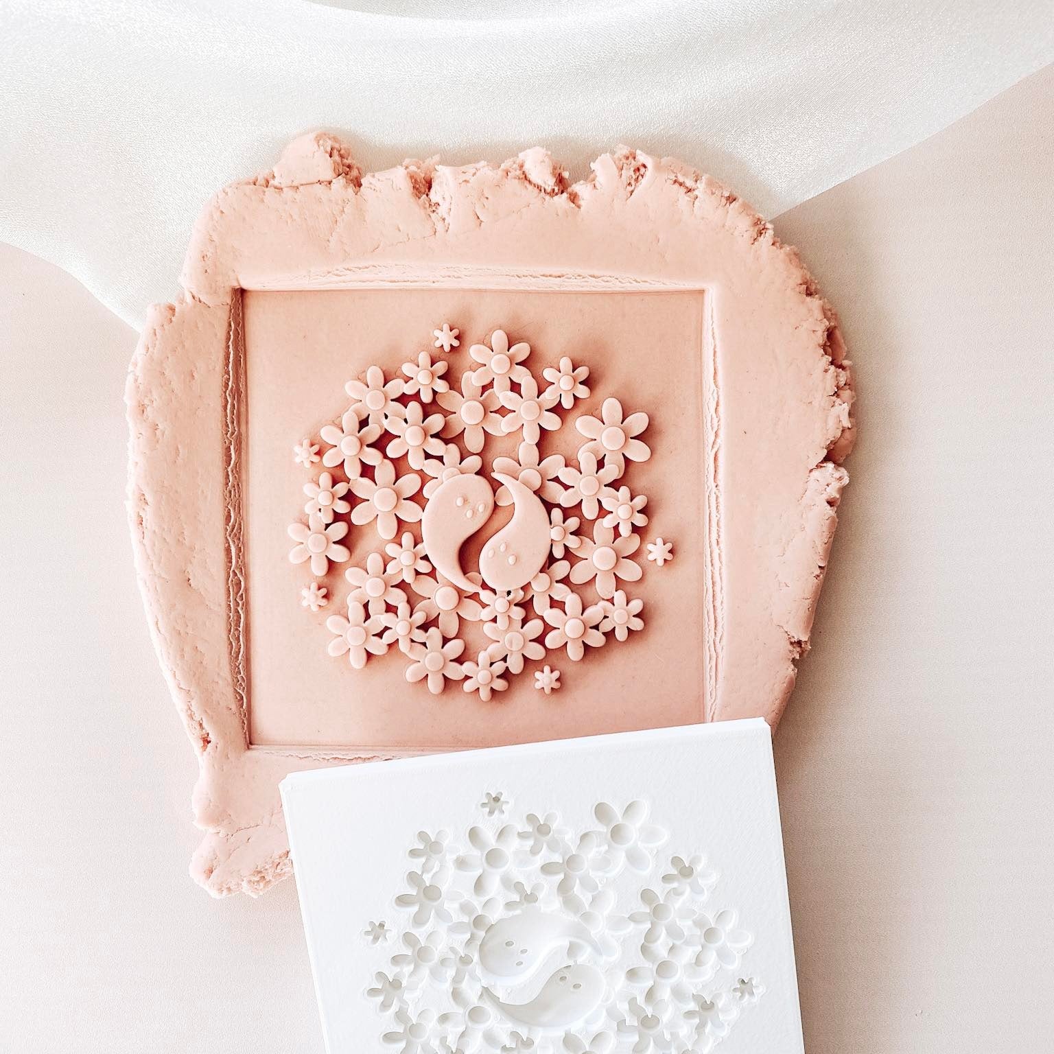 Ying Yang ghosts in a field of daisies debosser