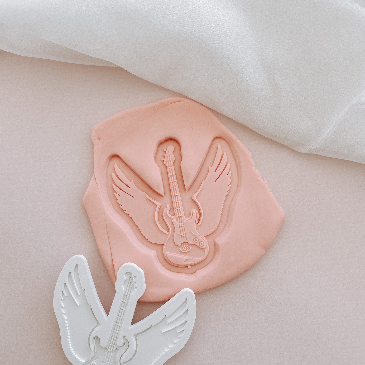 Guitar with wings debosser and cutter